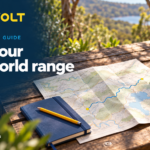 ZoomVolt guide banner showing a route map, notebook, helmet and water bottle on a table, headed Plan your real-world range.
